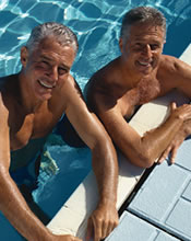 Older male sibling smiling in pool